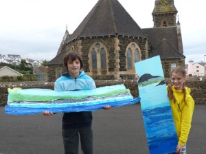 kids with artwork based on environment exploration on Castlerock beach Northern Ireland