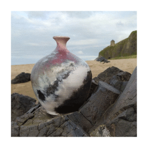 photo of vessel created by pit firing photographed on basalt rocks on Downhill Beach Northern Ireland