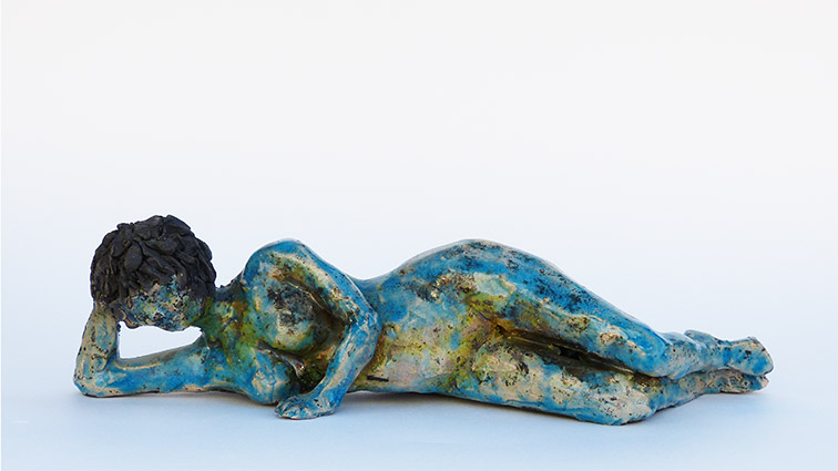 Figurative sculptural raku ceramics by Irish artist McCall Gilfillan laying on side front